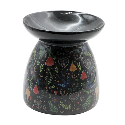 Decorative oil burner with colorful patterns on a black background