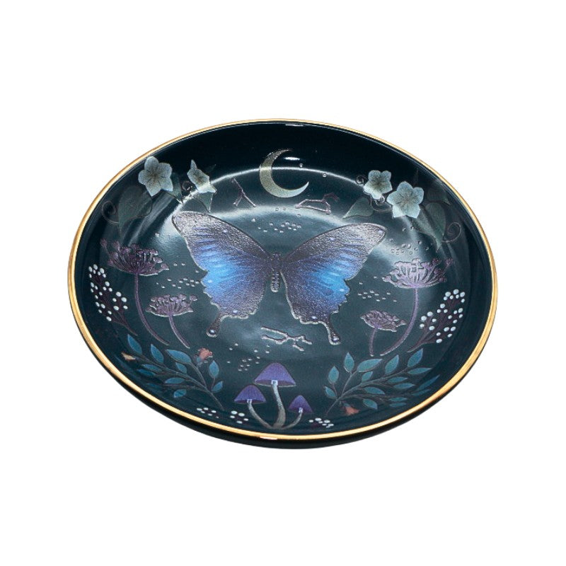 Decorative plate with butterfly and floral design on a dark background