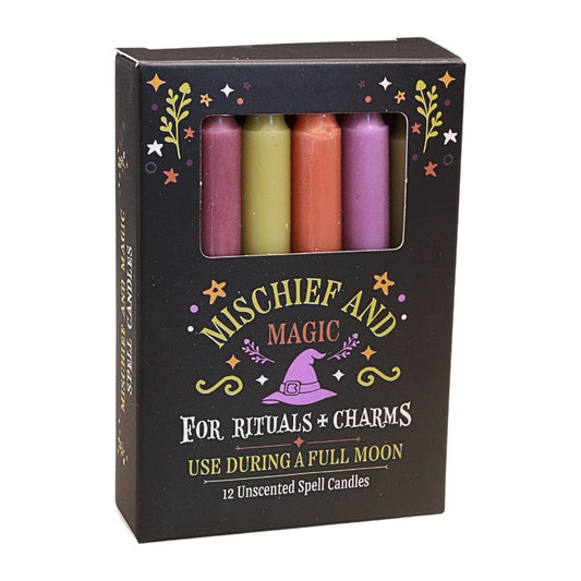 A black box of Mischief and Magic Unscented Spell Candies, featuring a window that displays four colorful wax candles ( yellow-green, orange, and light and dark purple) inside. The packaging is decorated with gold stars, green leaves, and a purple witch hat illustration.
