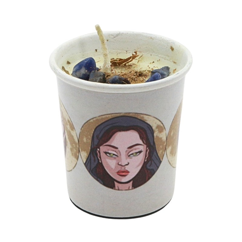Candle in a votive candle holder with a goddess face design on a white background