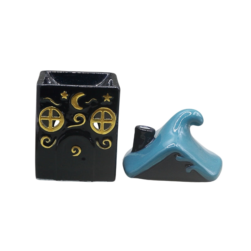 A small decorative ceramic set consisting of a  dark blue square box with gold moon, stars, and window motifs, alongside a blue and  dark blue wave-shaped lid, shown on a plain white background.