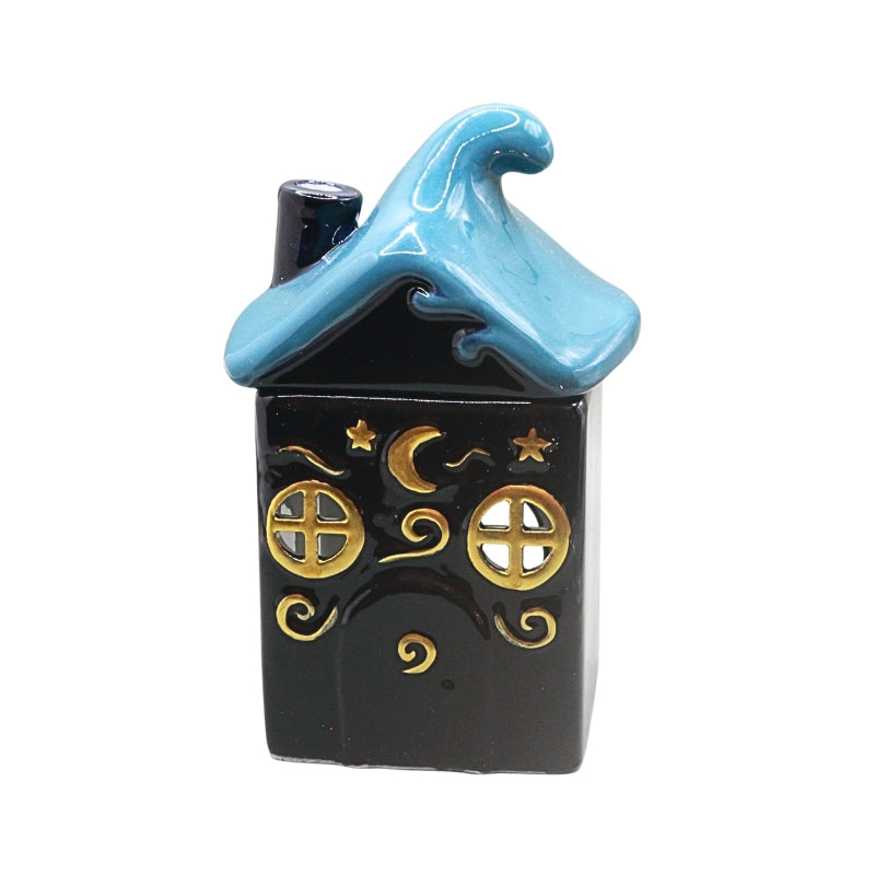 A small decorative house-shaped ceramic container or ornament with a dark blue body, a light blue wave-shaped roof, and gold celestial details including stars, a crescent moon, and window motifs, shown on a plain white background