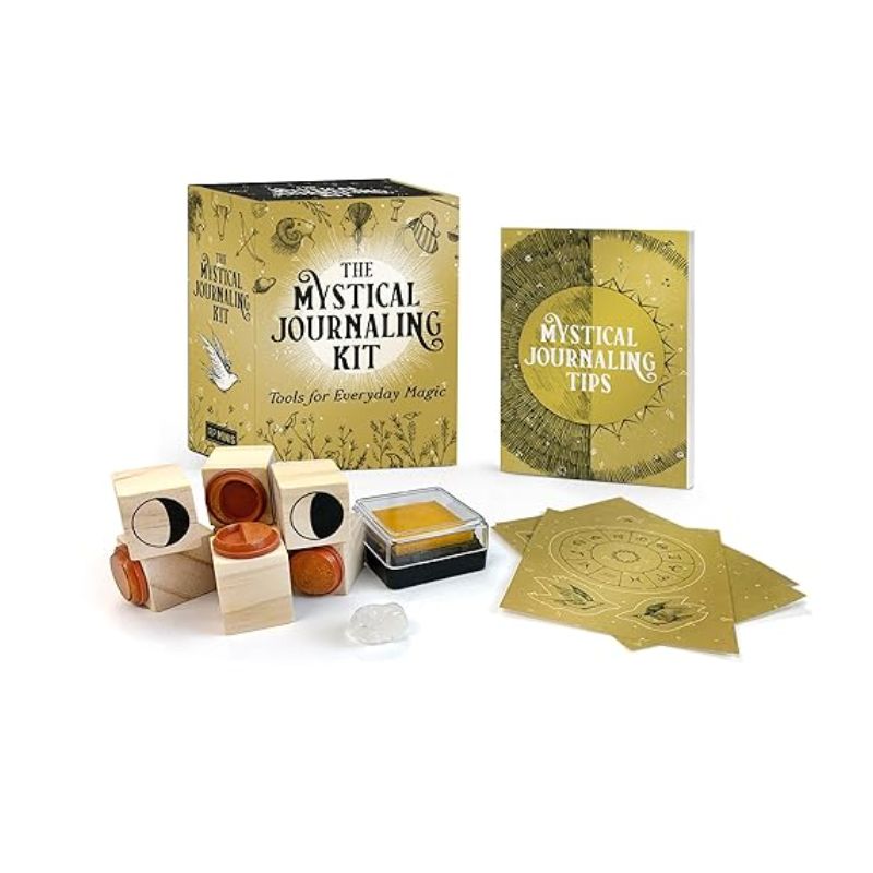 Mystical Journaling Kit with gold box, journaling tips booklet, wooden moon-phase stamps, ink pad, illustrated cards and a clear crystal.