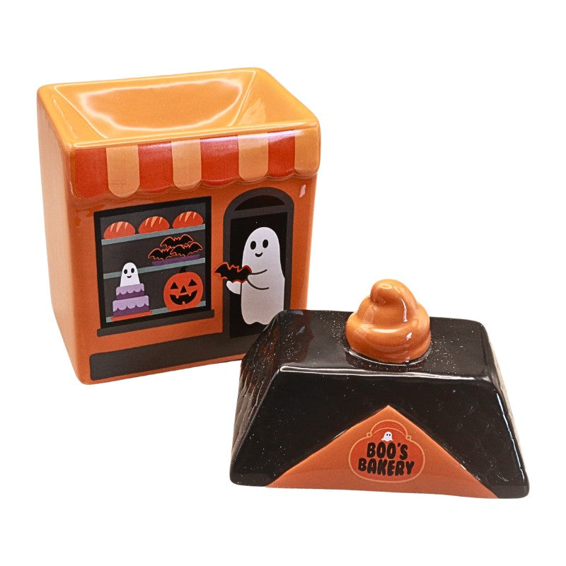 Halloween-themed ceramic cookie jar set featuring an orange bakery storefront container with a ghost and jack-o'-lantern window scene, and a black lid with an orange poop-shaped topper labeled 'BOO'S BAKERY'.