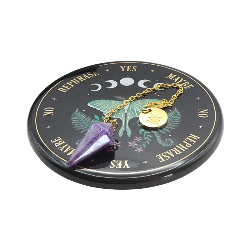 Crystal pendulum with a black pendulum board featuring moth symbols on a white background