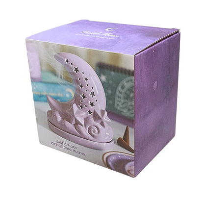 box showing a Purple ceramic moon shaped incense cone burner with star cut outs, on a white background