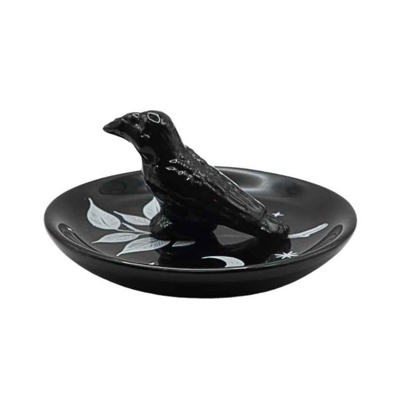 Black ceramic ring holder with a bird design on a white background