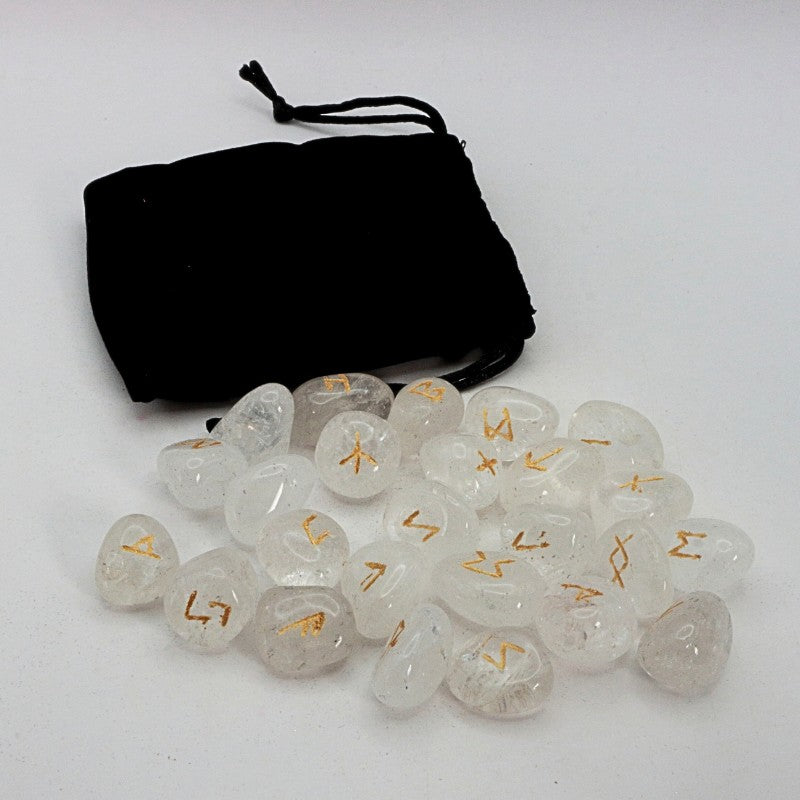 Set of crystal runes  with gold symbols on a white background, accompanied by a black drawstring bag.