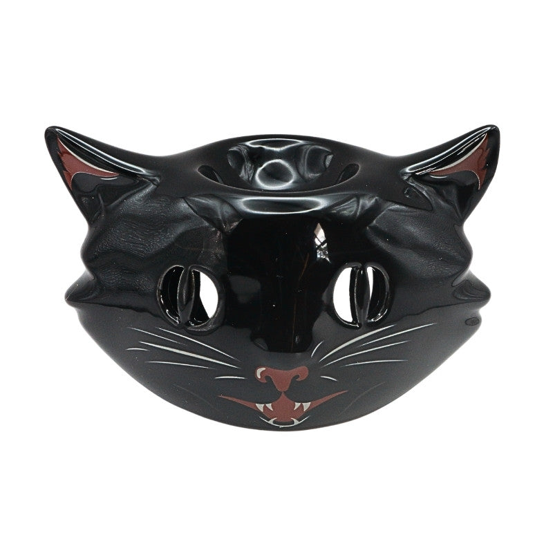 black ceramic oil burner with a cat face on front