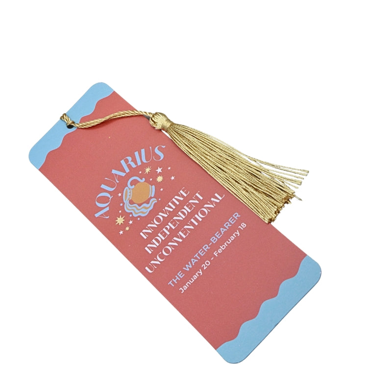 orange and blue bookmark with gold tassel and white and blue writing