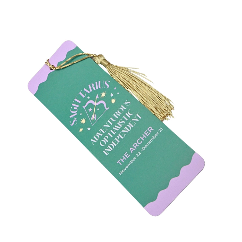 green and purple bookmark with gold tassel and white and purple writing, on a white background