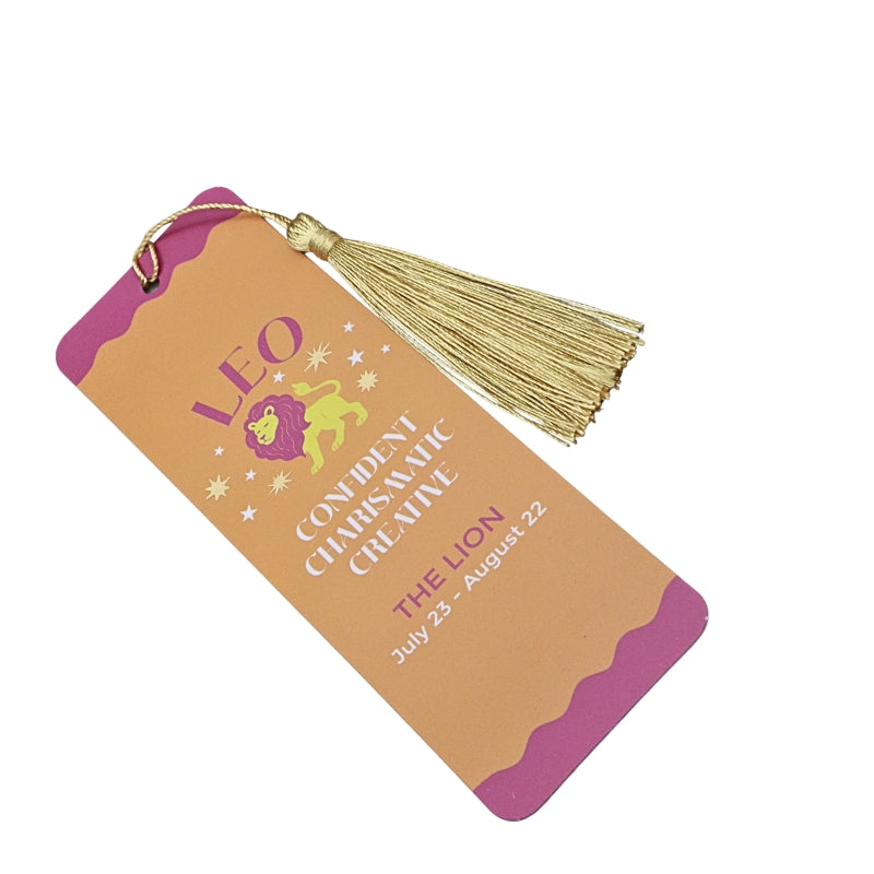 orange and pink bookmark with gold tassel and white and pink  writing, on a white background