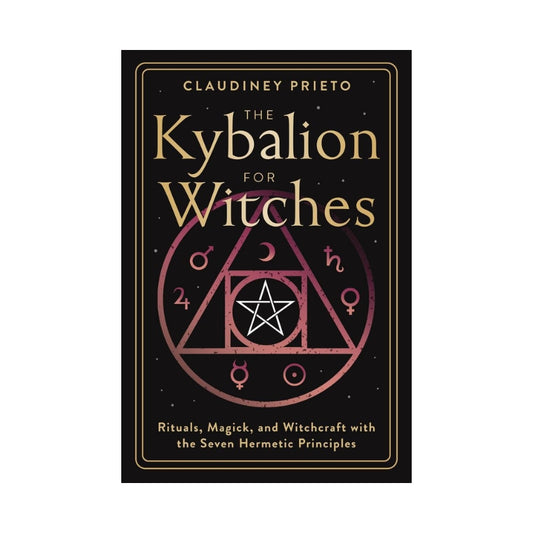 black book with gold writing saying the kybalion for witches