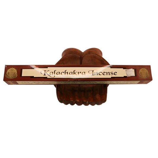 pk of natural tibetan dhoop incense on a pair of open wooden carved hands