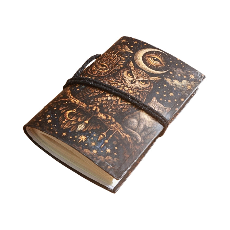 small notebook with brown tie and image of an owl and crescent moon, on  a white background
