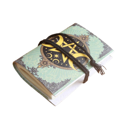 small notebook with brown tie and image of a pentacle and crescent moons either side, on  a white background