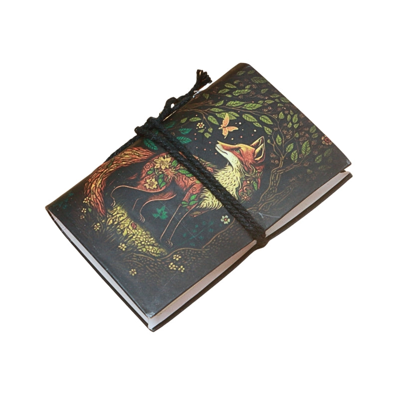small notebook with brown tie and image of a fox in the forest, on  a white background