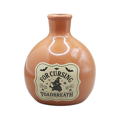 orange coloured ceramic bottle with a tapered neck and old style vintage label that reads "for cursing toadbreath"