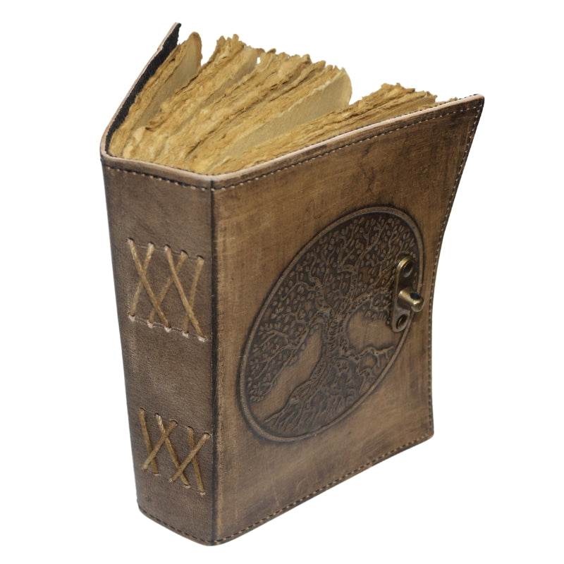 Antique style brown leather journal with the tree of life on the cover and a brass closure. Inside contains plain "antiqued" pages . Leather lacing criss crosses across the spine of the book.