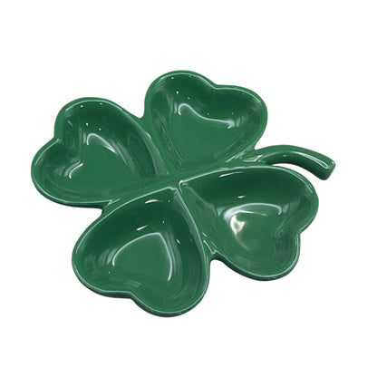 Green four-leaf clover-shaped dish on a white background