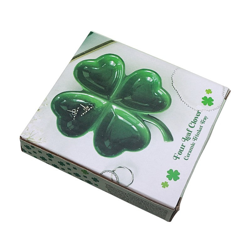 Four-leaf clover-shaped ceramic trinket tray in packaging with shamrock design