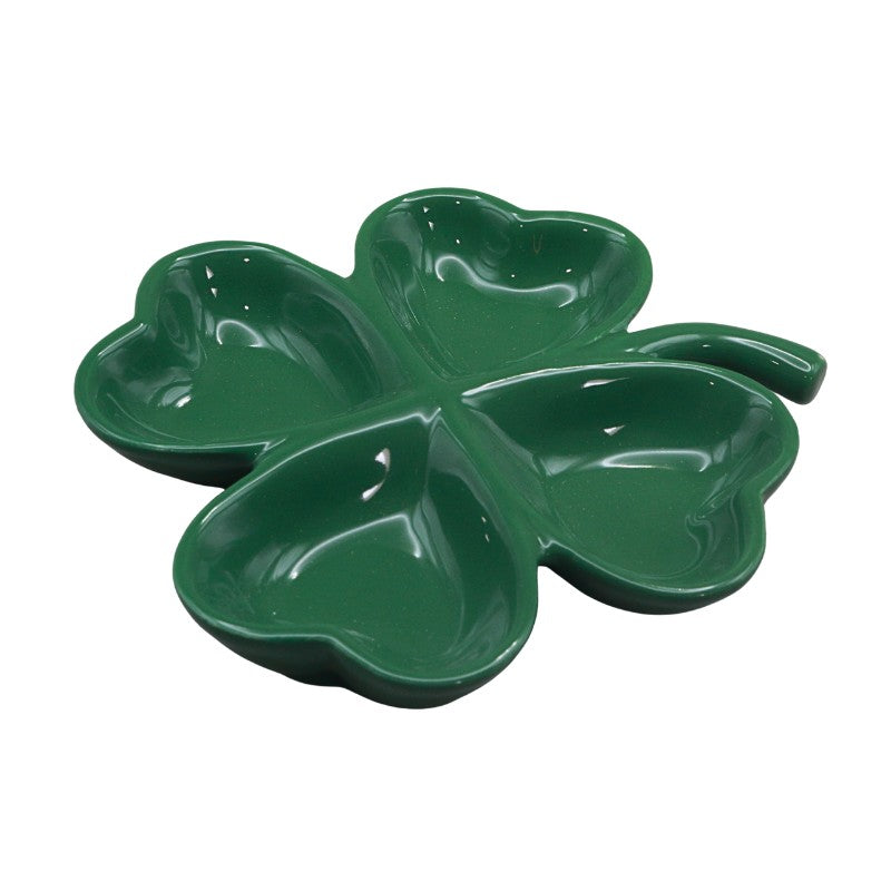 Green four-leaf clover-shaped dish on a white background
