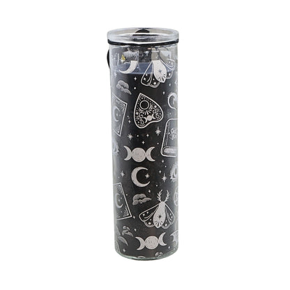 A tall, cylindrical glass tumbler with a clear lid, featuring a black body decorated with white celestial and occult-themed illustrations including moons, stars, a tarot card, a butterfly, and pentacles.