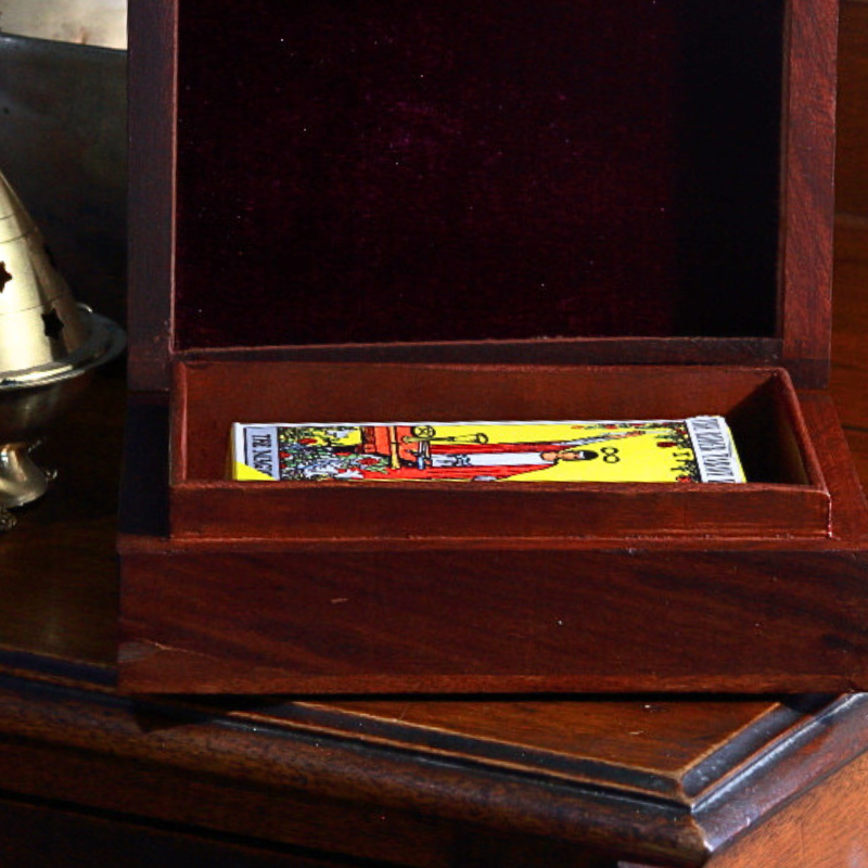 carved wooden box holding a standard sized deck of tarot cards 