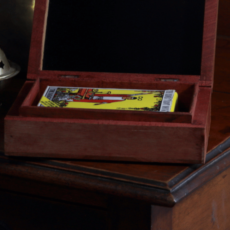 carved wooden box with a pack of standard size rider waite tarot cards in it