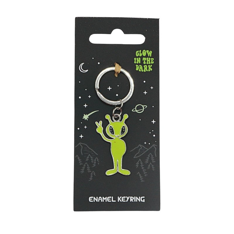 Green alien enamel keyring on a black card with 'Glow in the Dark' text