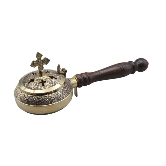 Brass incense burner with wooden handle on a white background