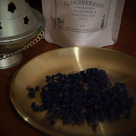 Elderberries on a gold plate with a labeled package in the background