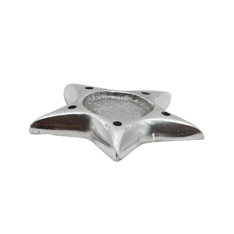 Metallic star-shaped incense holder on a white background