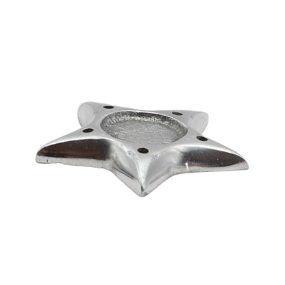 Metallic star-shaped incense holder on a white background