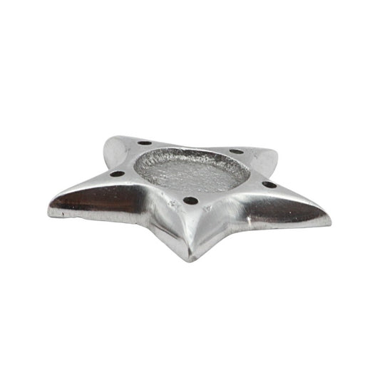 Metallic star-shaped incense holder on a white background