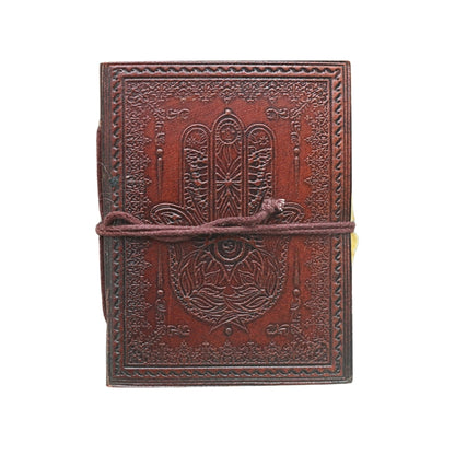 brown leather journal, embossed with image of a hand, with a brown tie, on a white background