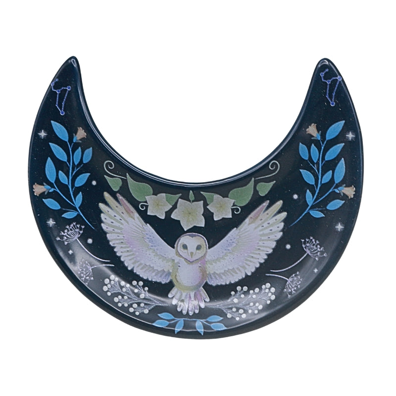 Decorative plate with an owl design and floral designs on a white background