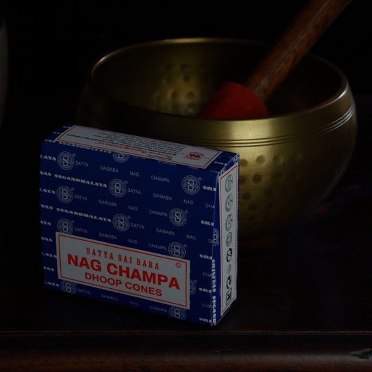 box of satya brand incense cones in front of a brass singing bowl