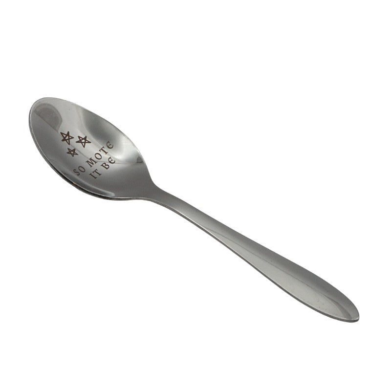 Silver spoon with engraved text on a white background