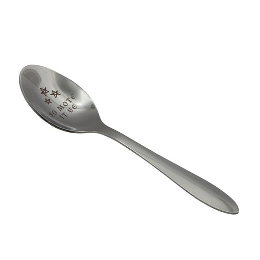 Silver spoon with engraved text on a white background