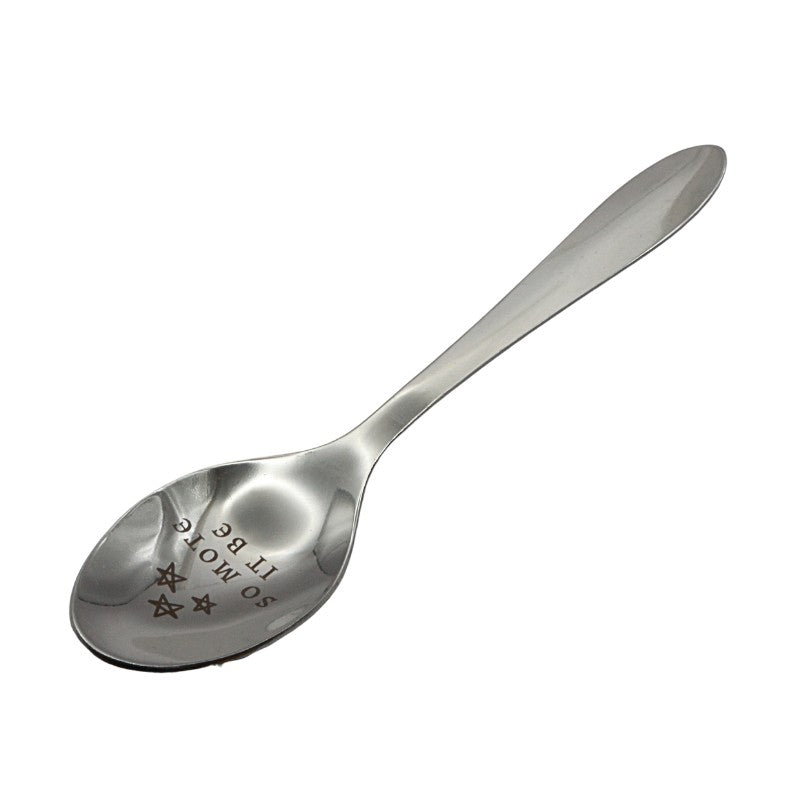 silver spoon engraved with text on white background
