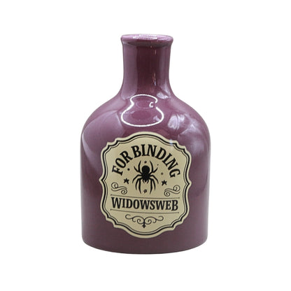A small glossy purple bottle with a cream label reading 'FOR BINDING WIDOWSWEB' and featuring a spider graphic, isolated on a white background.