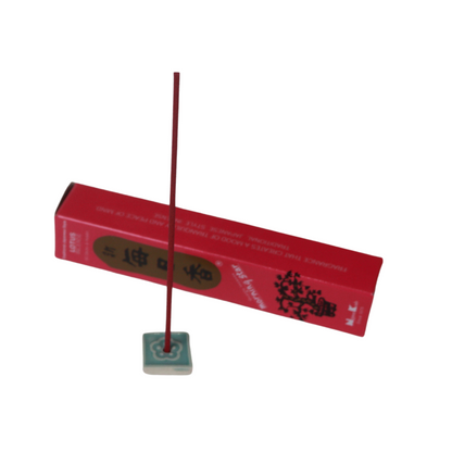 blue and white incense tile holding a lotus scented incense stick in front of the lotus incense box