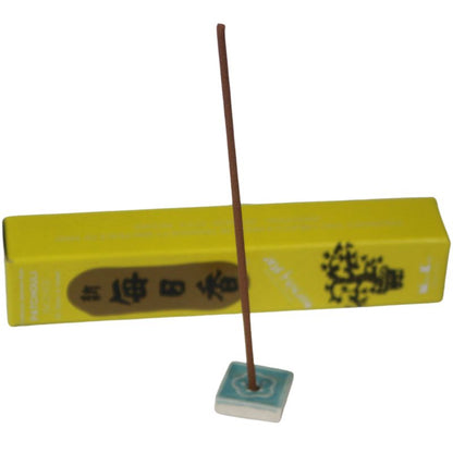  rectangle box of japanese morning star "Patchouli" incense sticks next to a tile incense holder